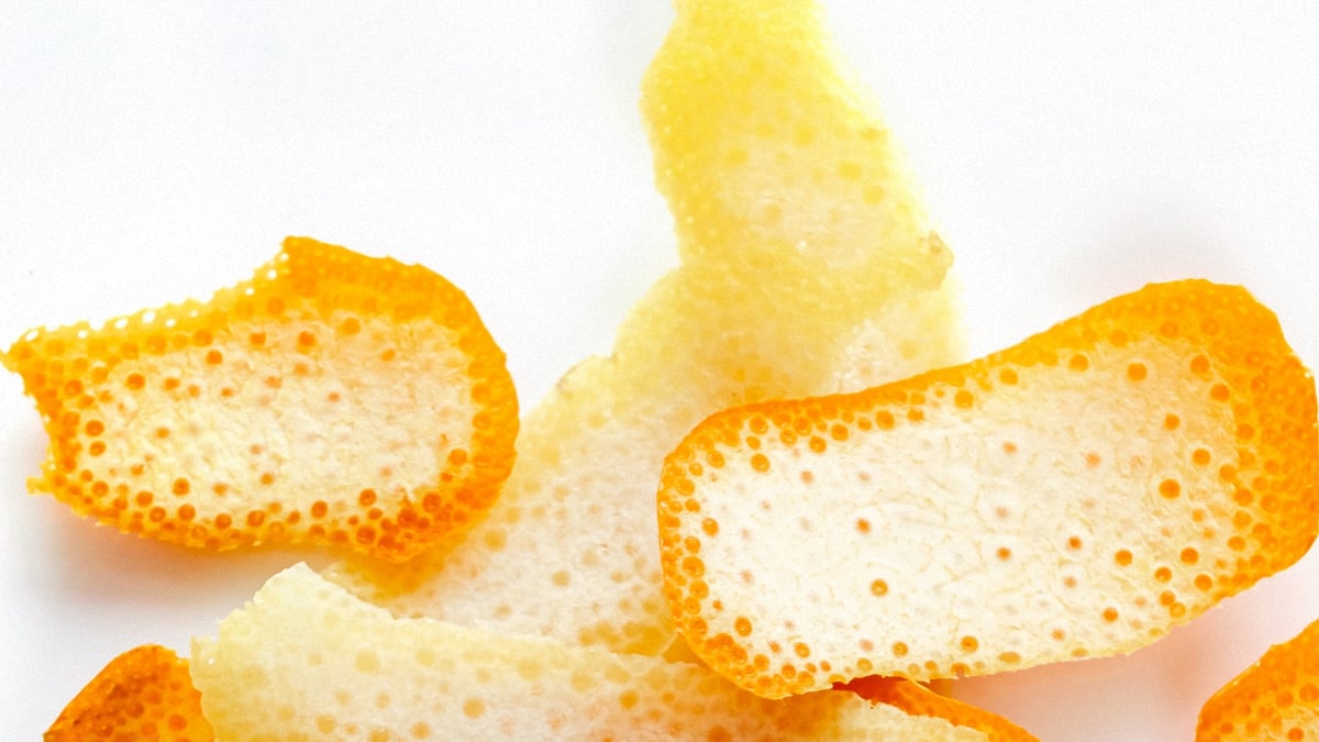 Orange fruit peels lying on a pure white background