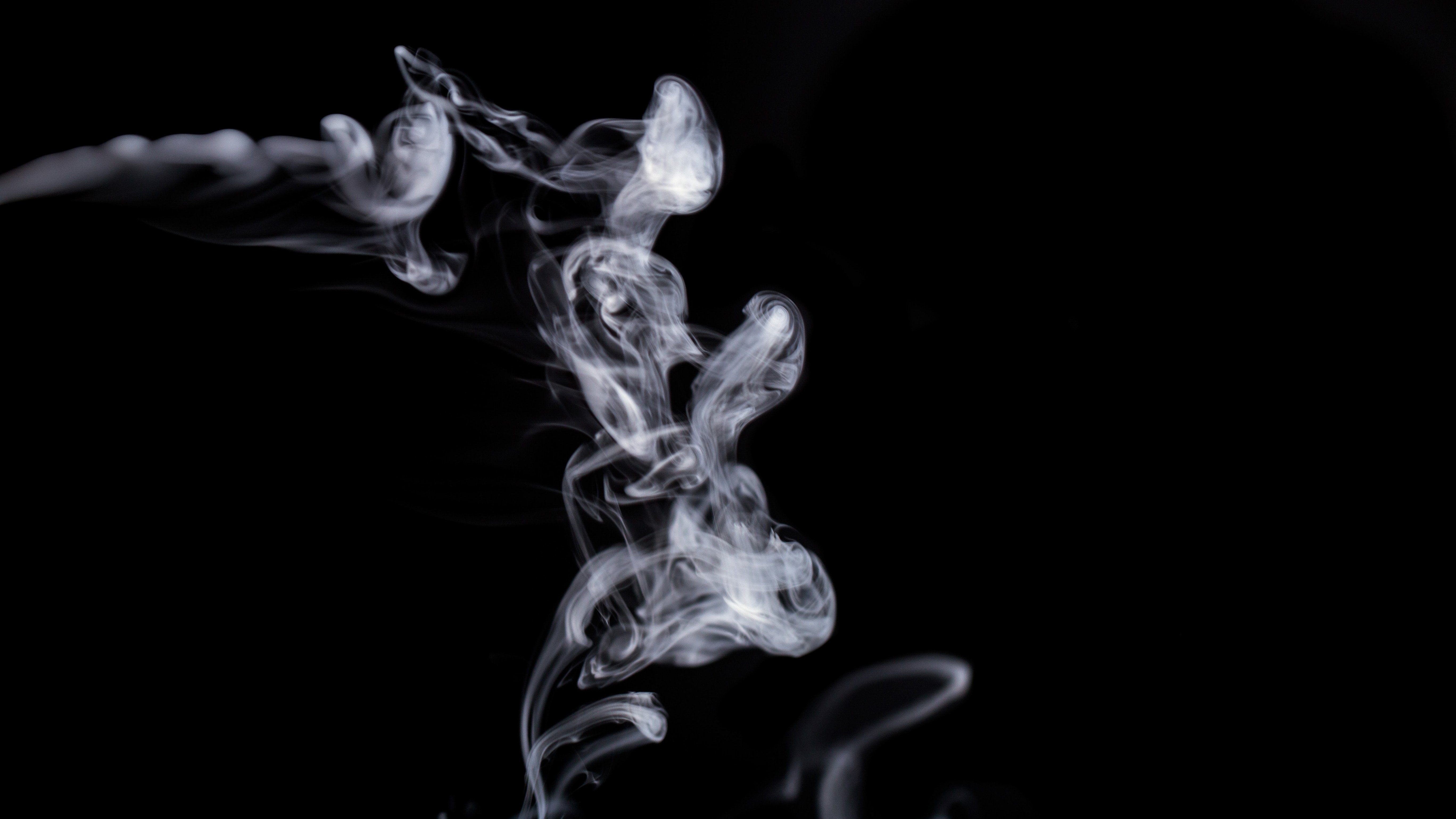 cannabis smoke floating in black background