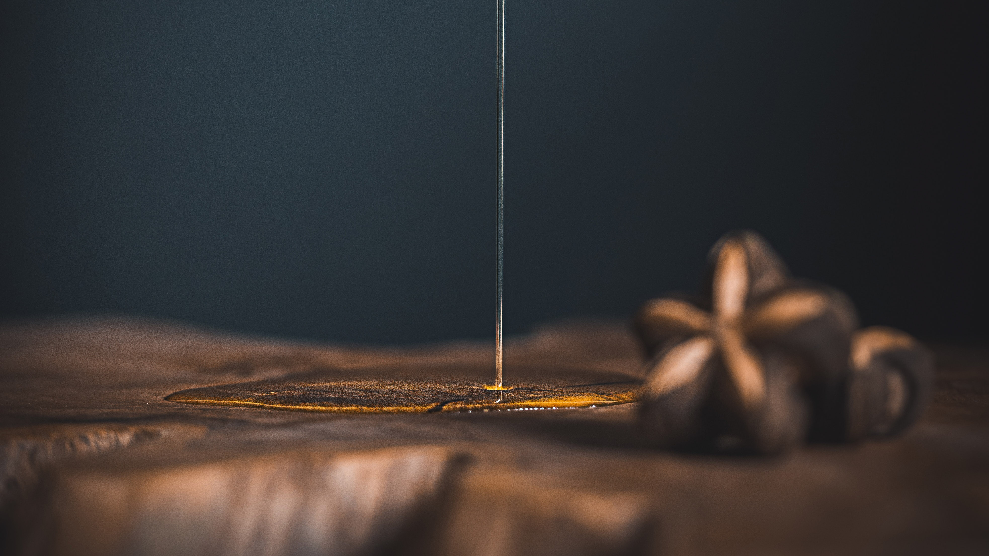 Cannabis cooking oil dropping into a brownish surface