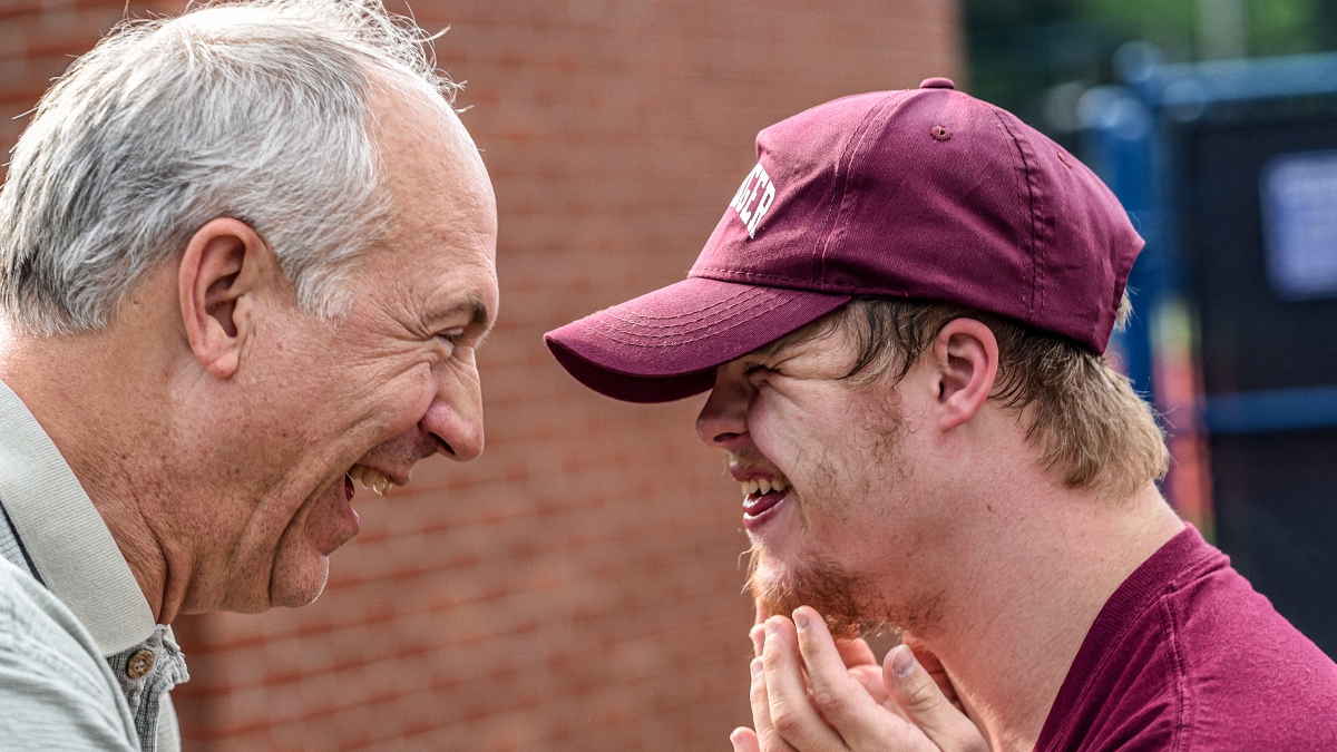 two men laughing and having a good time with one another