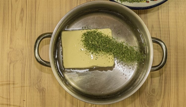 Image of a metal pot with canabis and butter inside