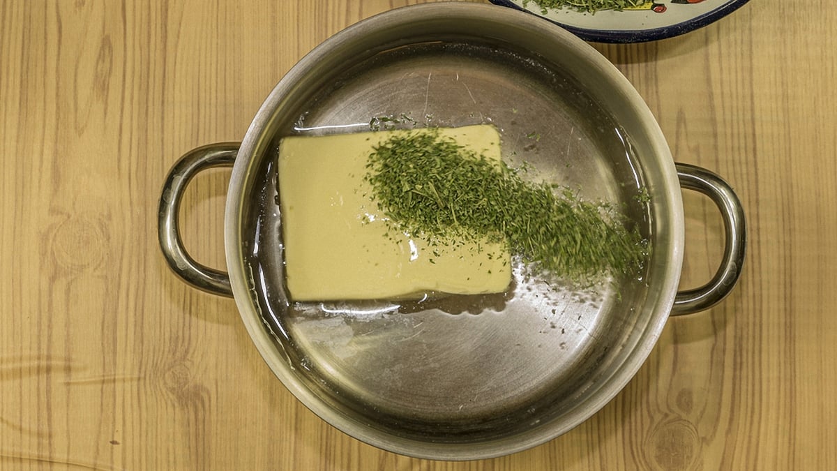Image of a metal pot with canabis and butter inside