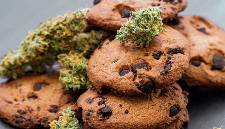 Image of multiple cookies with cannabis buds lying on top of each other