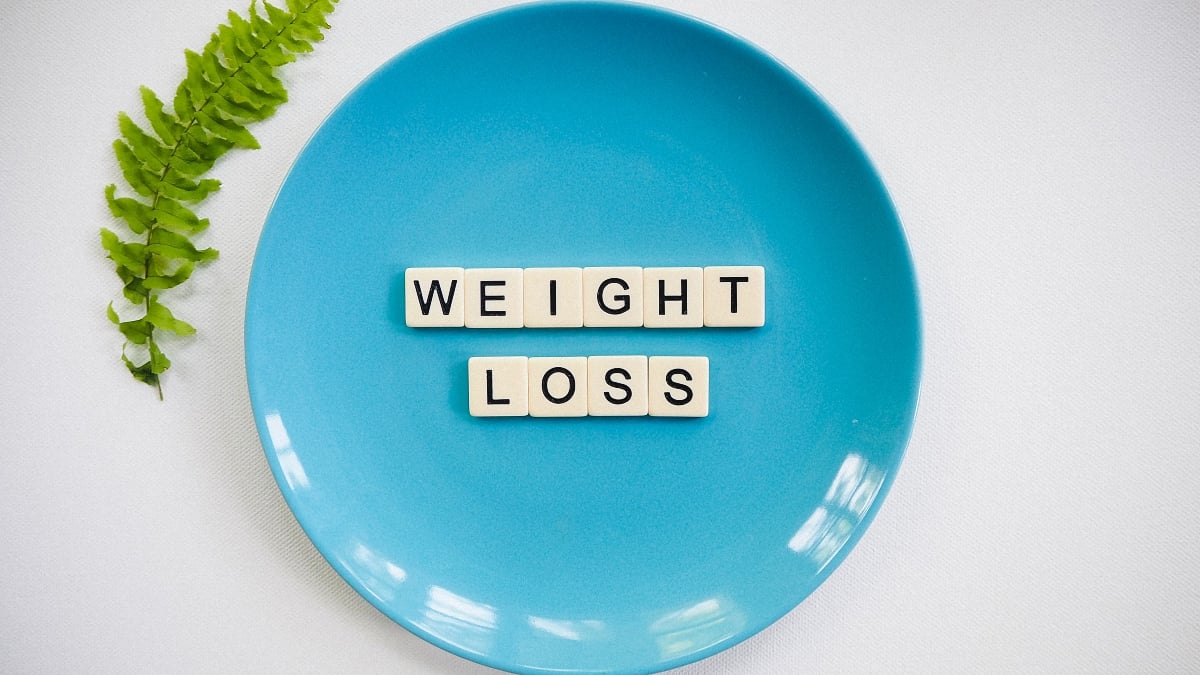 A blue plate with alphabetical cubes that read weight loss