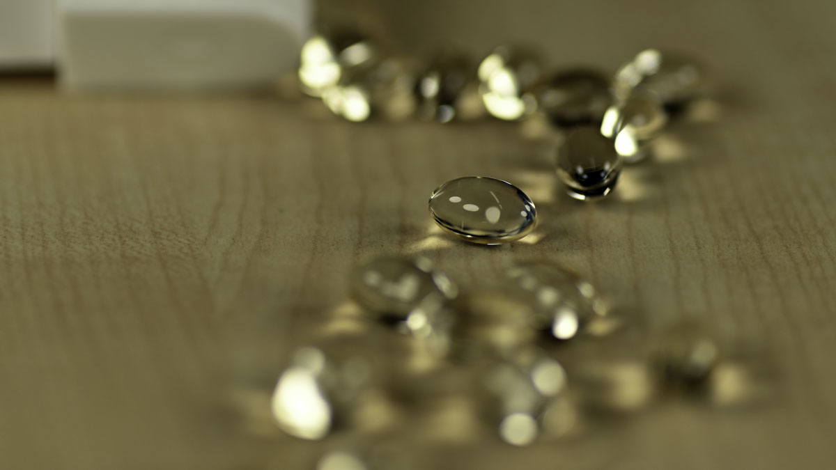 CBD oil gel tablets on a wooden table