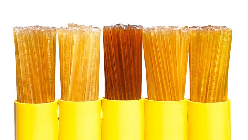 Various types of CBD honey sticks in white background