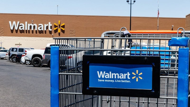 An abandoned shopping cart in front of a Walmart store