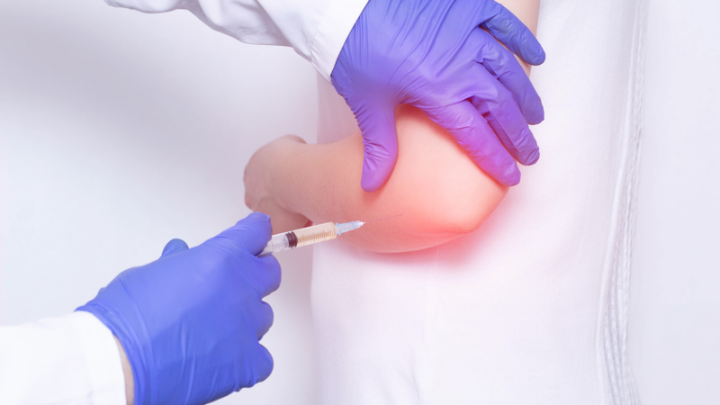 Doctor makes plasma-lifting injections into the girl s inflamed joint to relieve pain and inflammation, a modern anti-inflammatory method