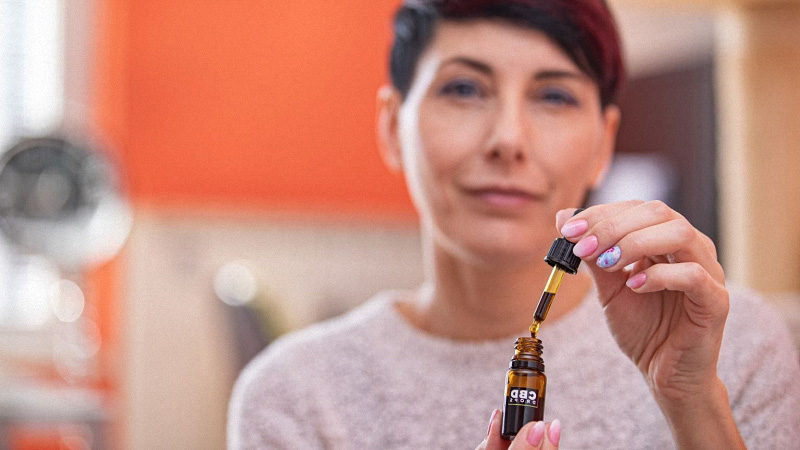 Women taking CBD oil for Shingles Pain