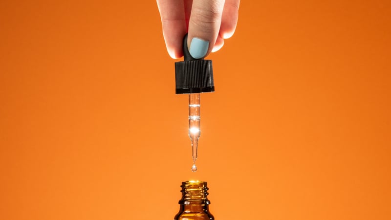 taking out the dropper from cbd oil bottle