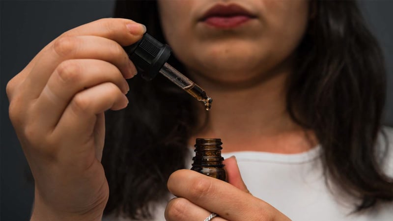 a women is taking cbd oil