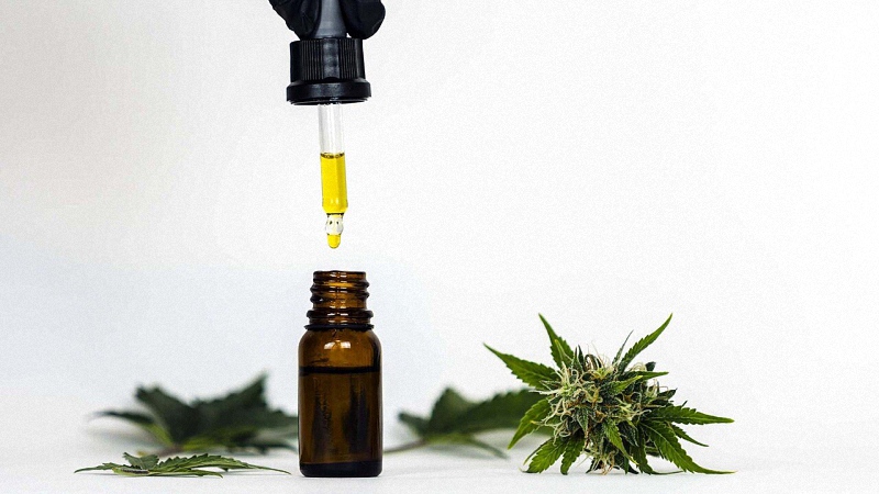 CBD Oil with Hemp Plants in White Background