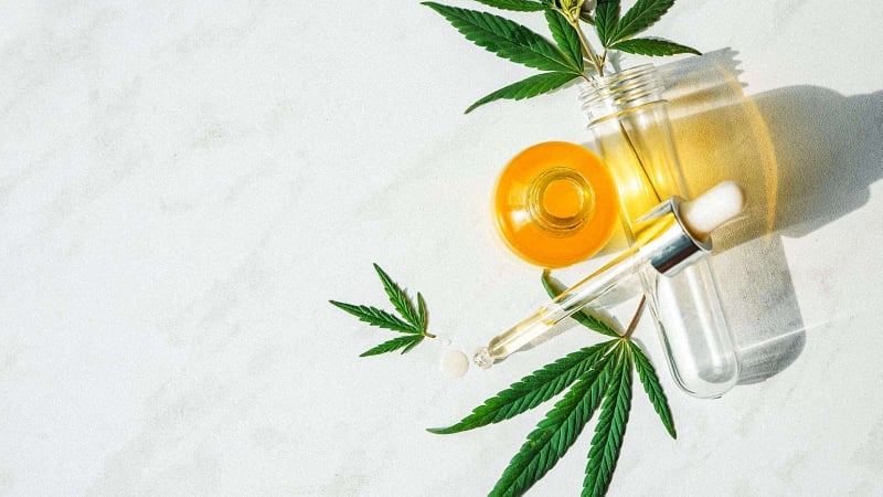 CBD Oil with Hemp Leaves in a White Background