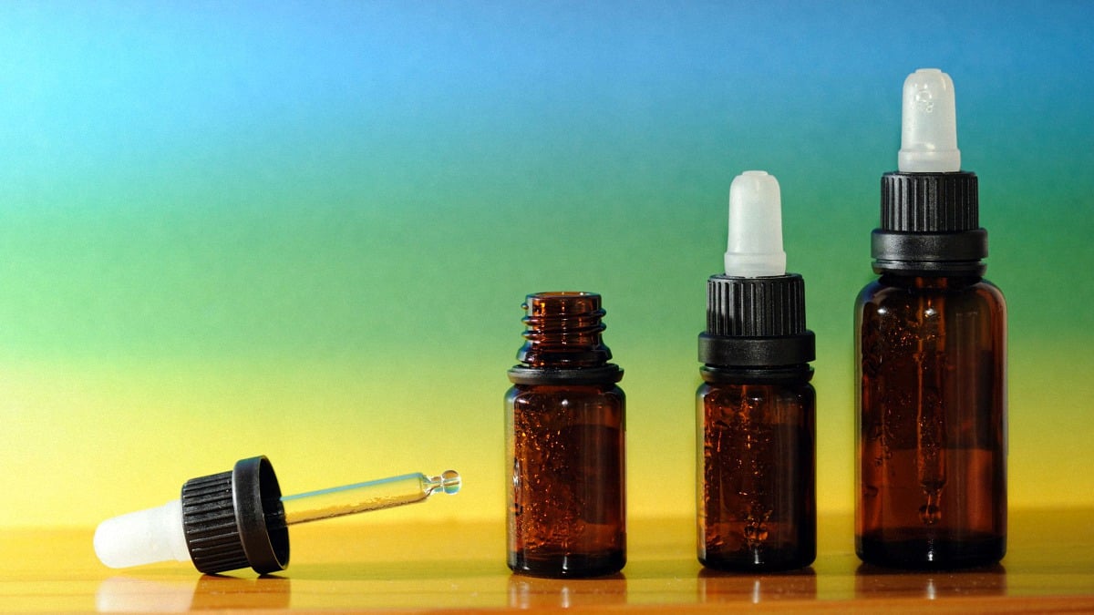 CBD Oil in a Bottle with Colors Background