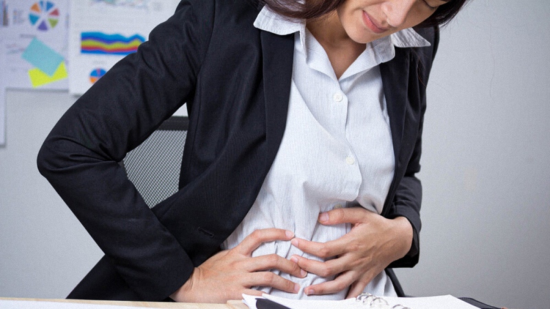 Woman Holding Her Aching Stomach Due to IBS